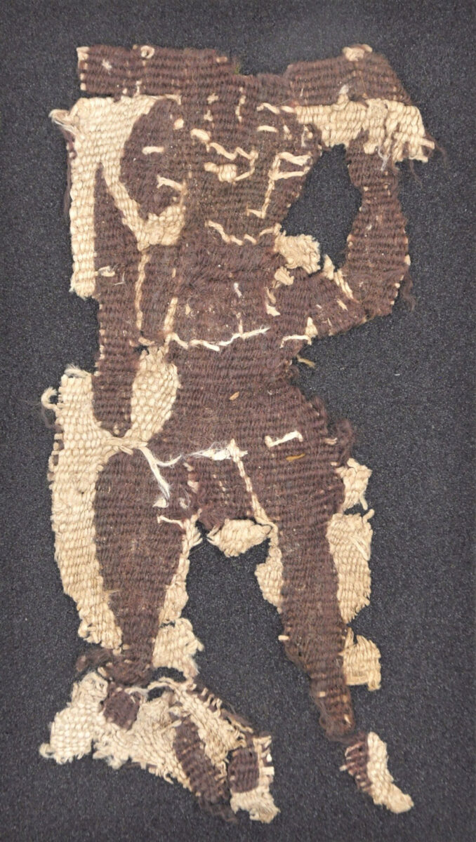 Θραύσμα υφάσματος (αρ. κατ. ΑΙΓ 8385), που απεικονίζει γυμνή χορεύτρια, Μαινάδα, Διόνυσο ή κάποιο άλλο μυθολογικό πρόσωπο. (Φωτογραφικό Αρχείο Εθνικού Αρχαιολογικού Μουσείου)